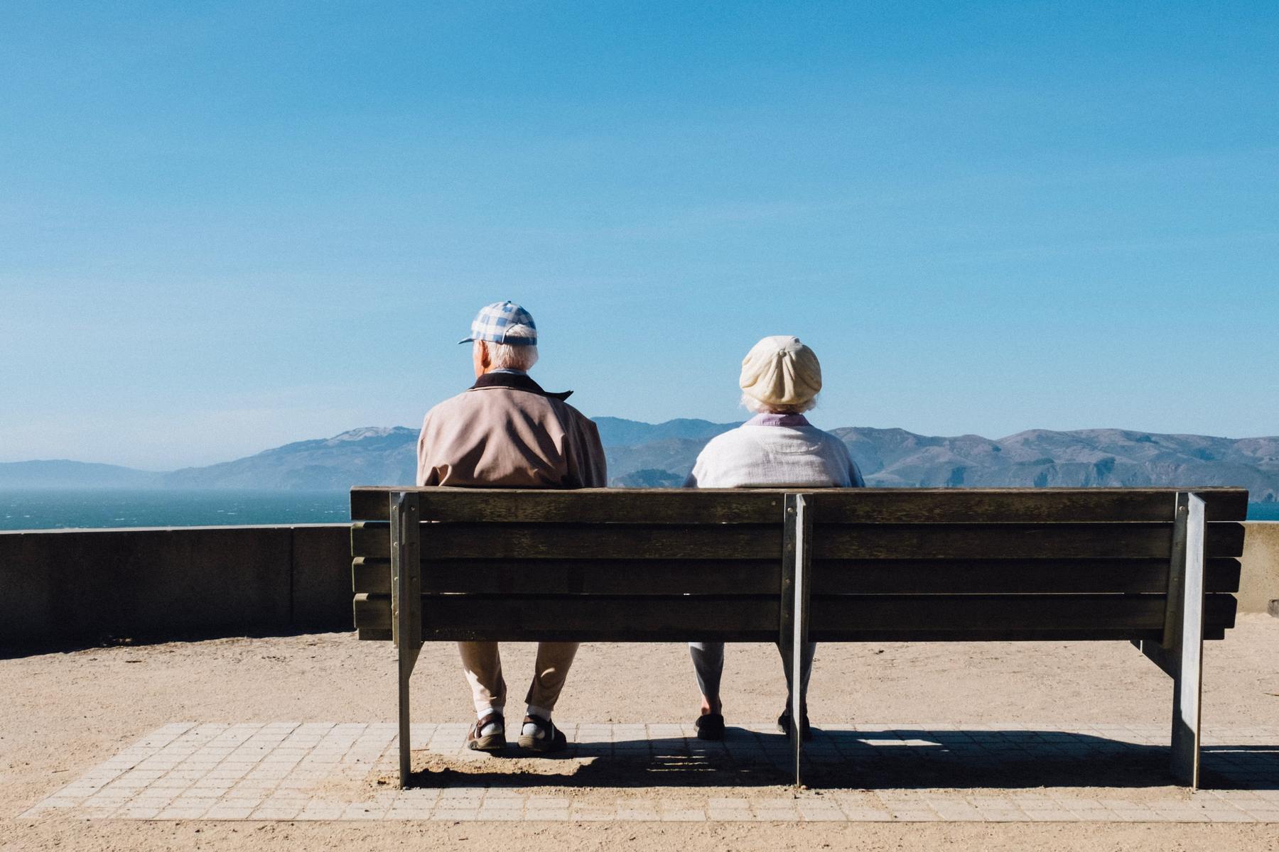 a person sitting on a bench overlooking the ocean